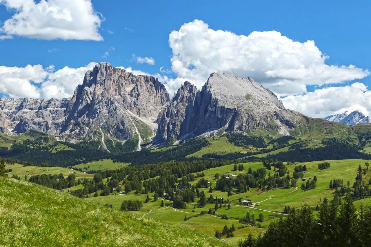 Sassolungo and Sassopiatto, Alpe di Siusi The Sassolungo and Sassopiatto group rising above the meadows of Alpe di Siusi, the destination for the excursion when rivers are not fishable.