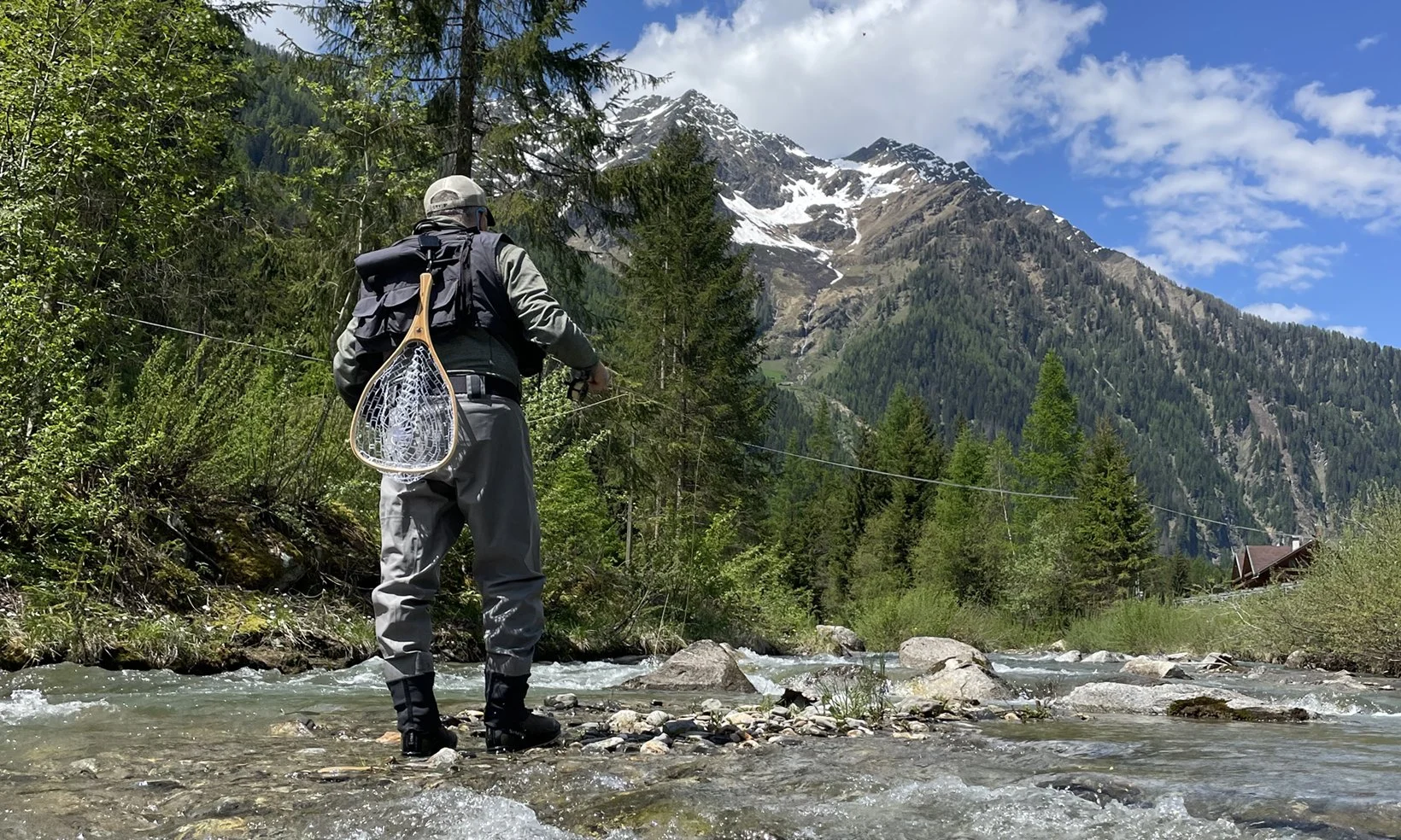Fly fishing in the alpine scenery of Rio Molini and Lake Neves, South Tyrol.