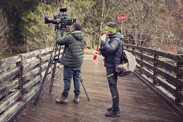 Two cameramen setting up film equipment for "Tucci in Italy" series in Trentino.