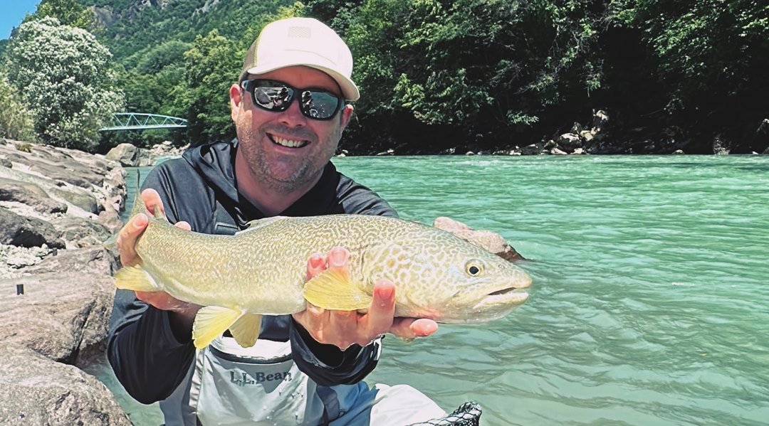 A trophy catch demonstrating the best Marble Trout fishing Italy experiences in the Dolomites.